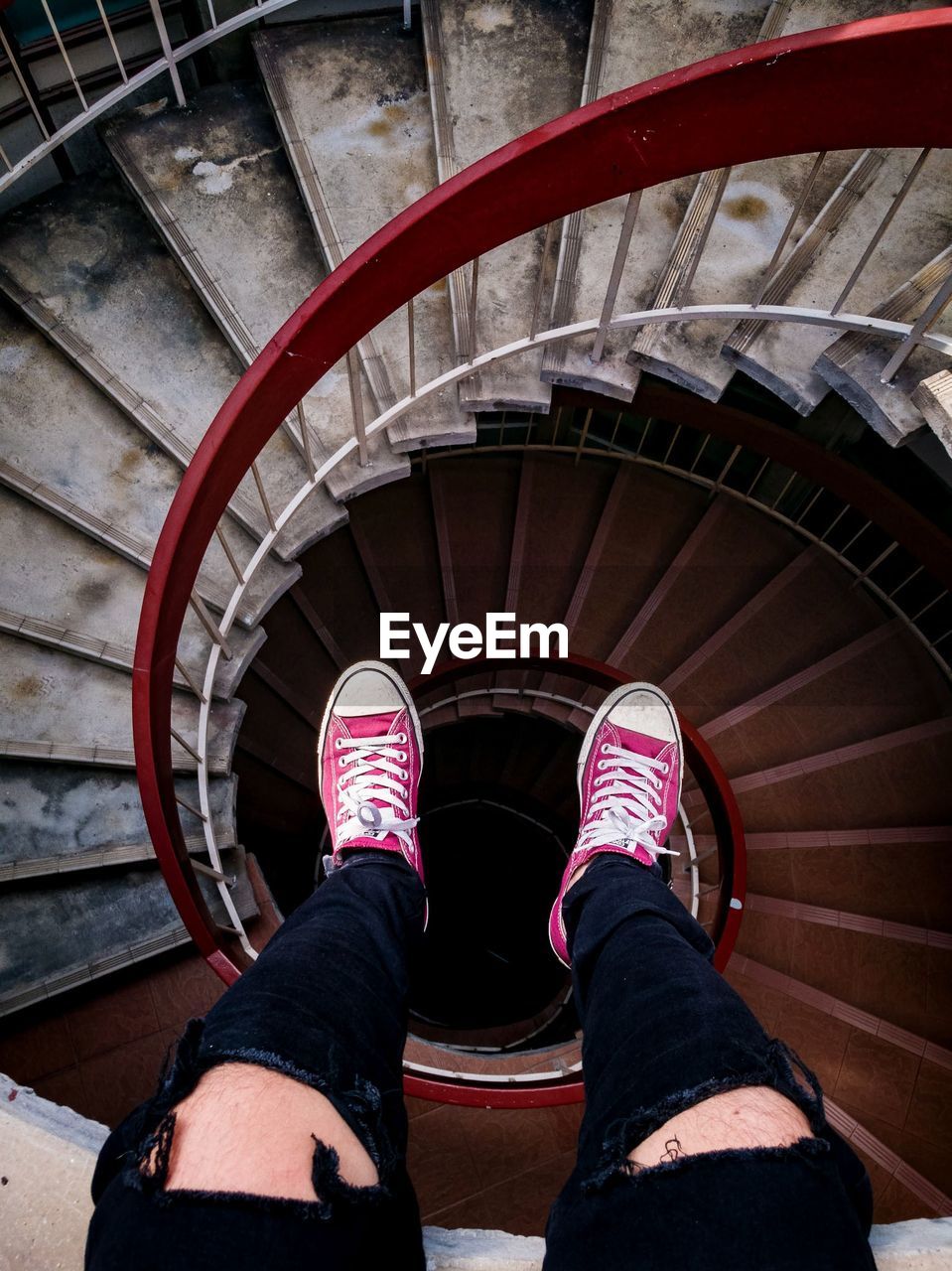 Low section of woman on spiral staircase