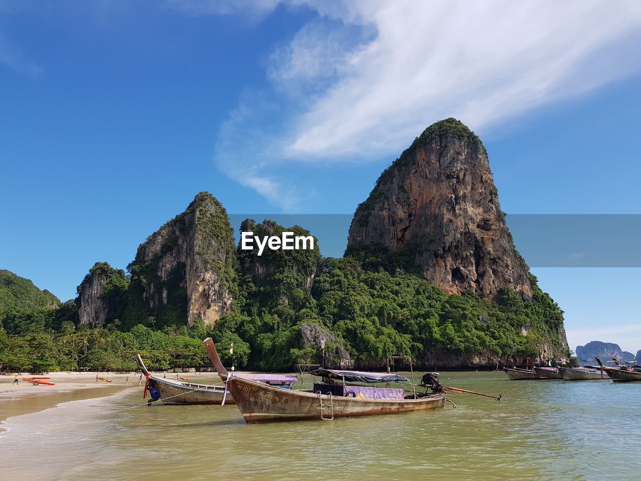 BOATS MOORED ON SEA AGAINST ROCK FORMATION