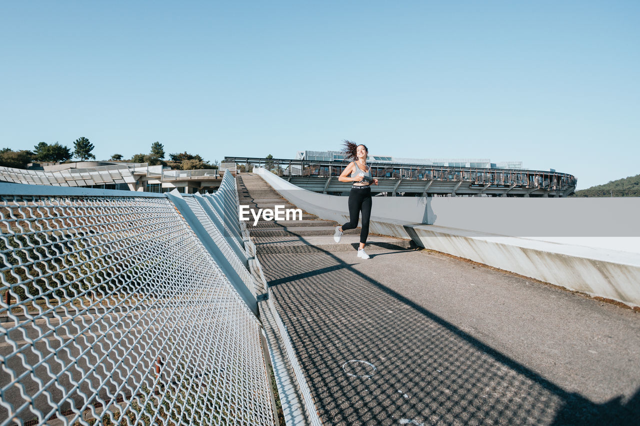 Female athlete running on steps