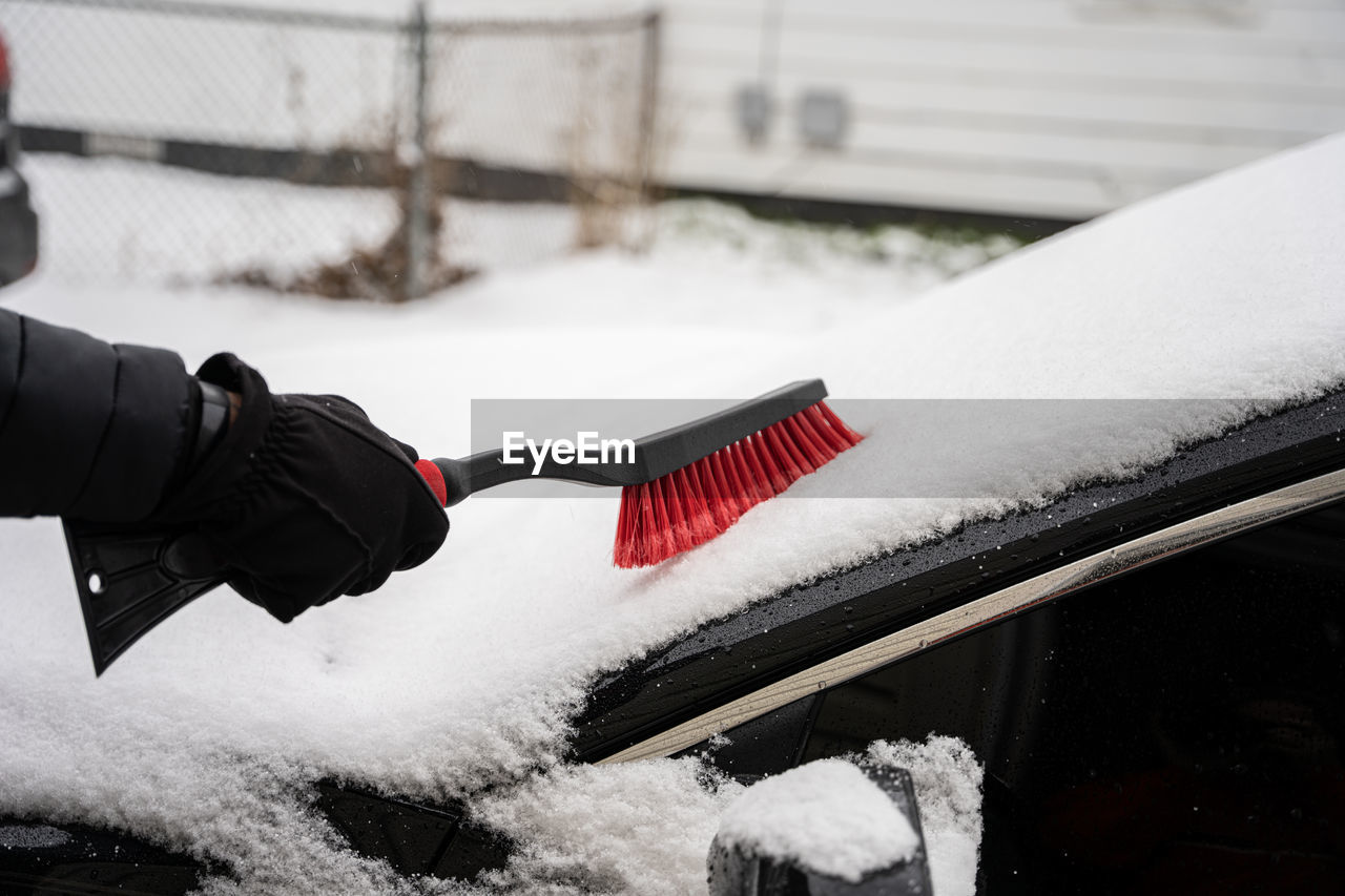 Fresh snow is cleared with a snow brush from your windshield