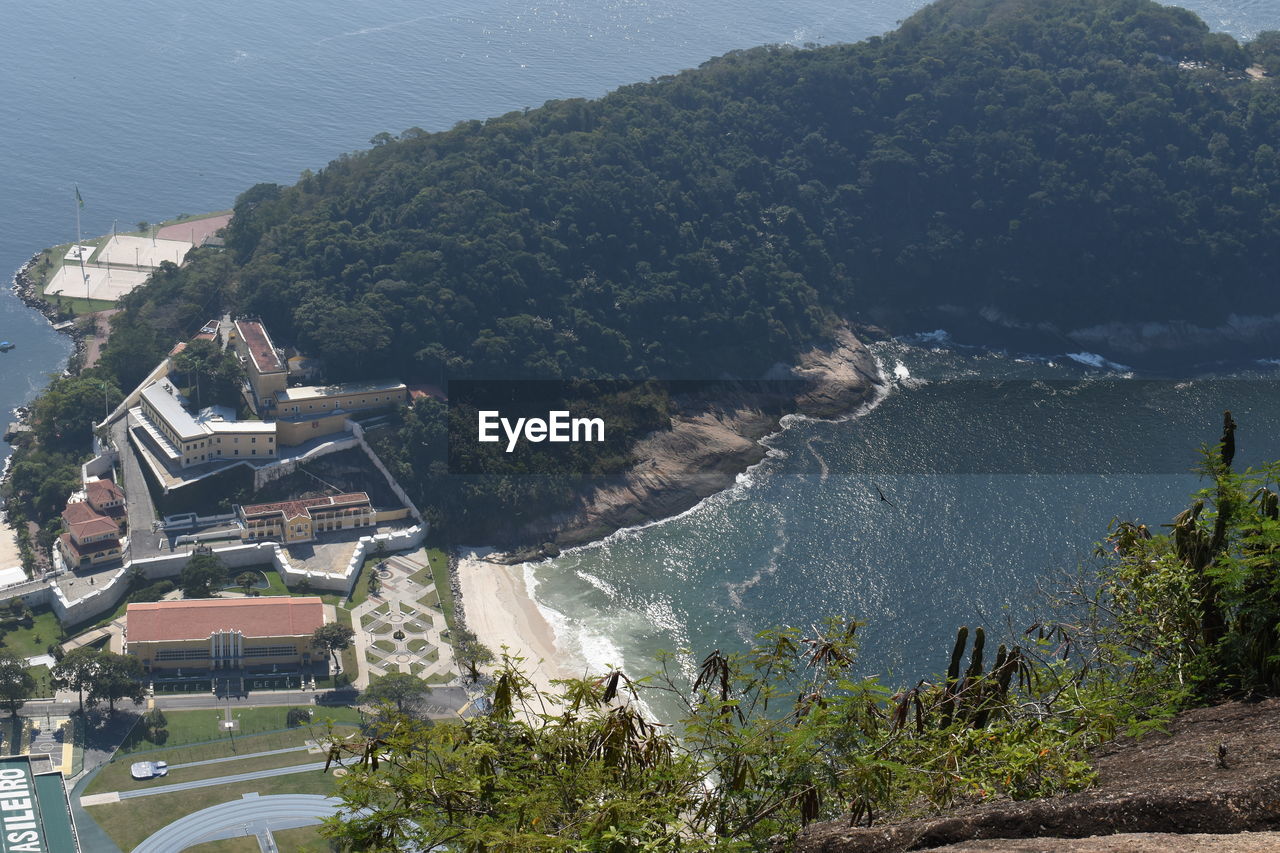 High angle view of trees and sea against mountain