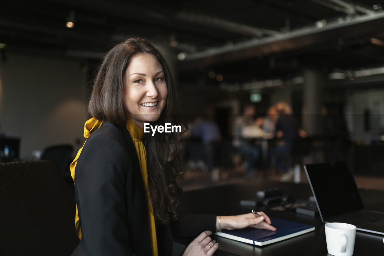 Smiling businesswoman looking at camera