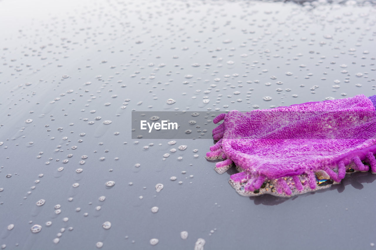 Close-up of wet purple towel on floor