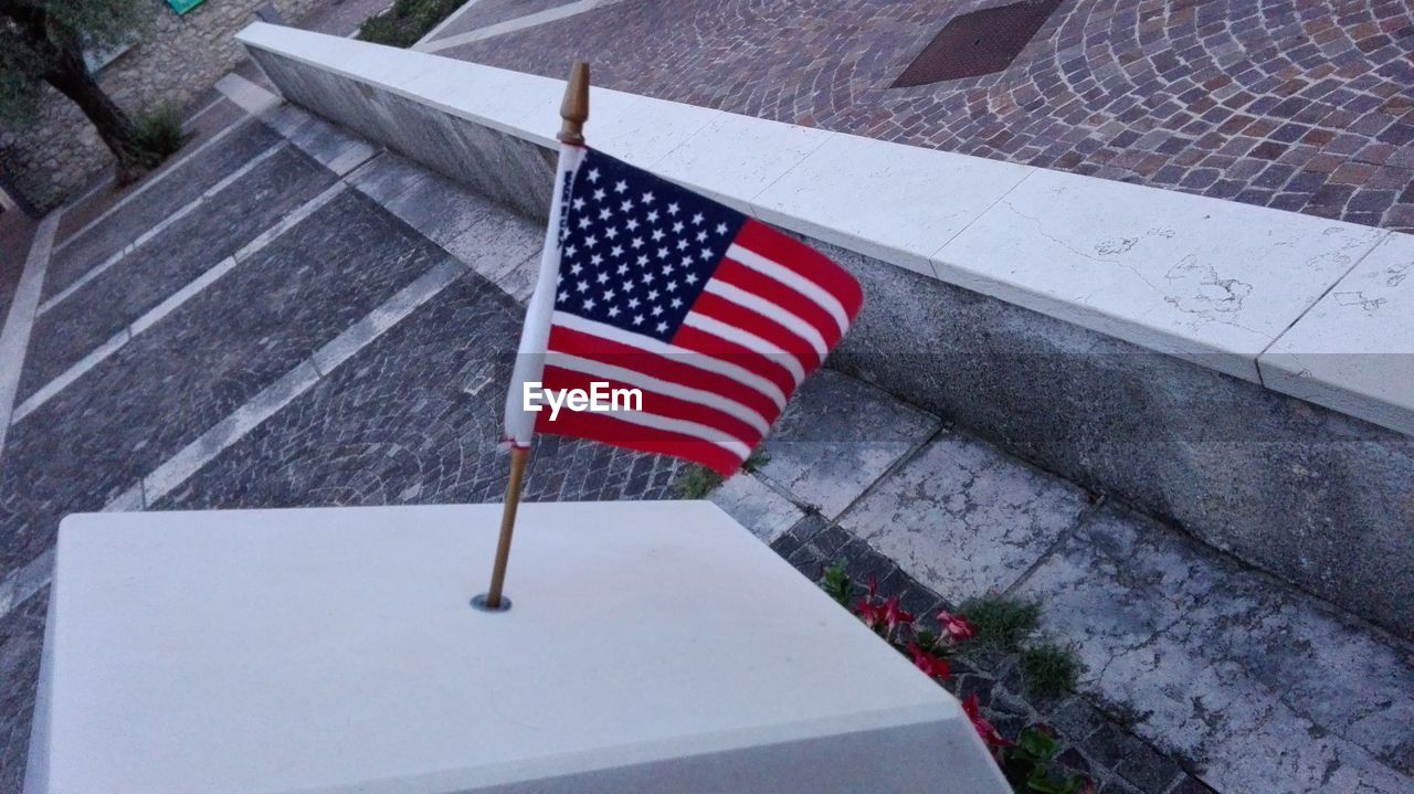 American flag on tombstone at cemetery