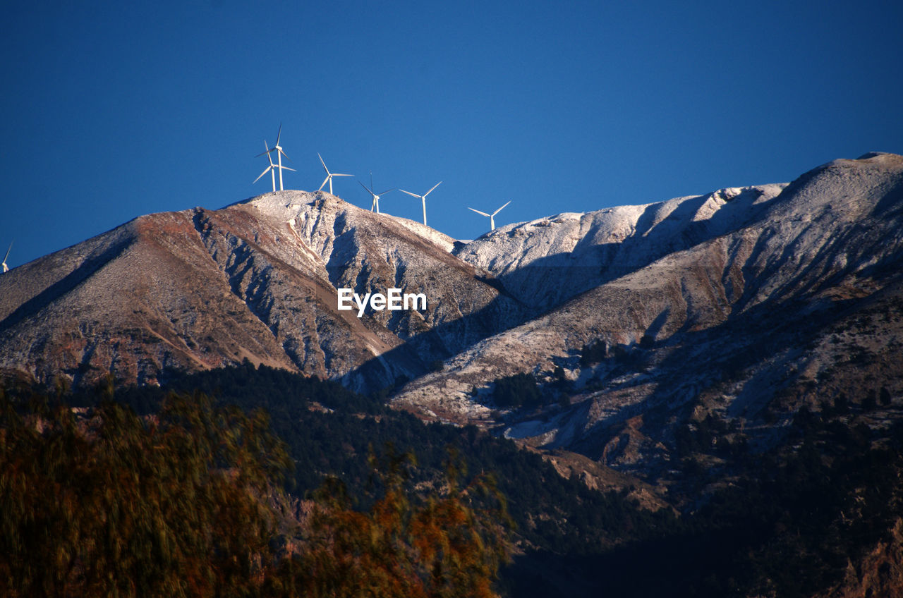 Scenic view of mountains against clear blue sky