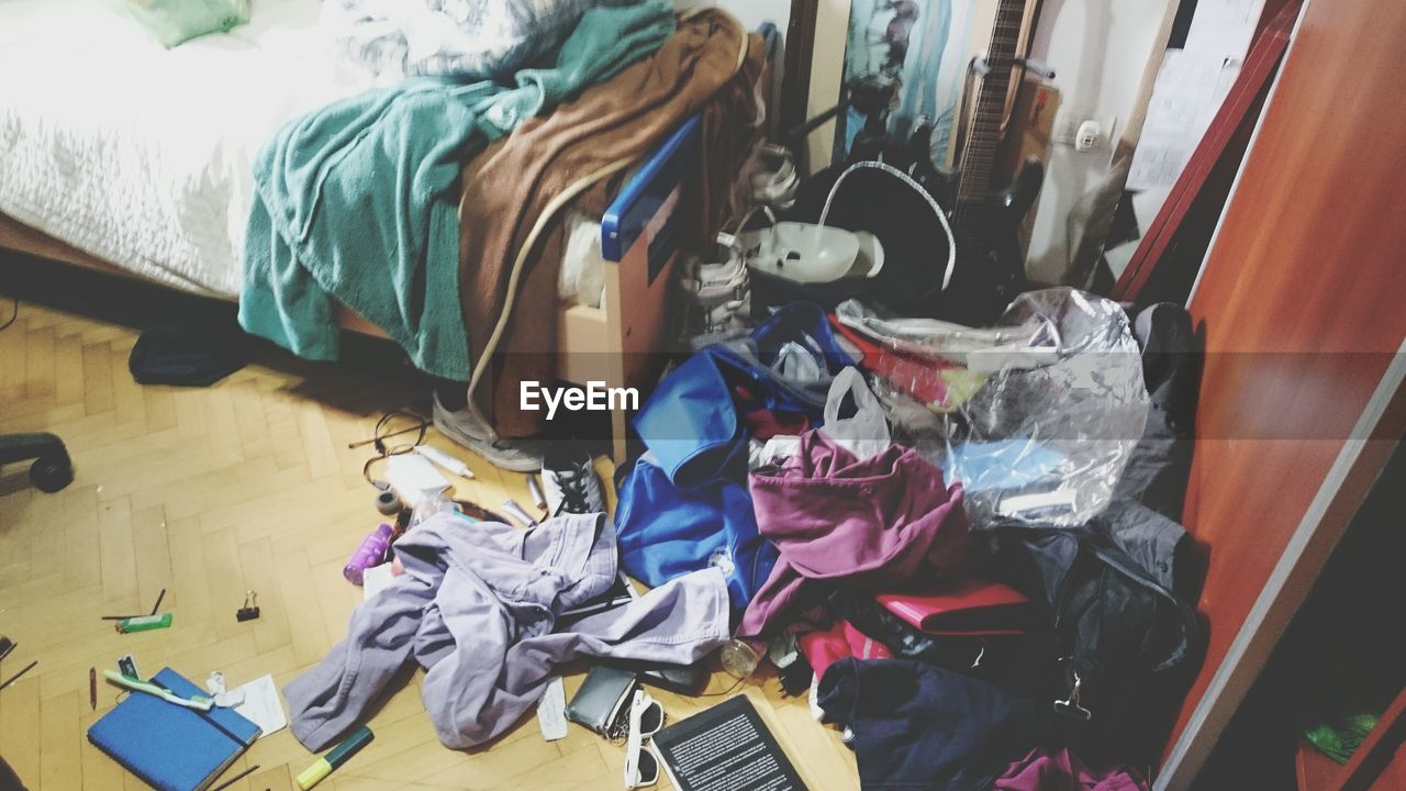 High angle view of clothes by bed at home