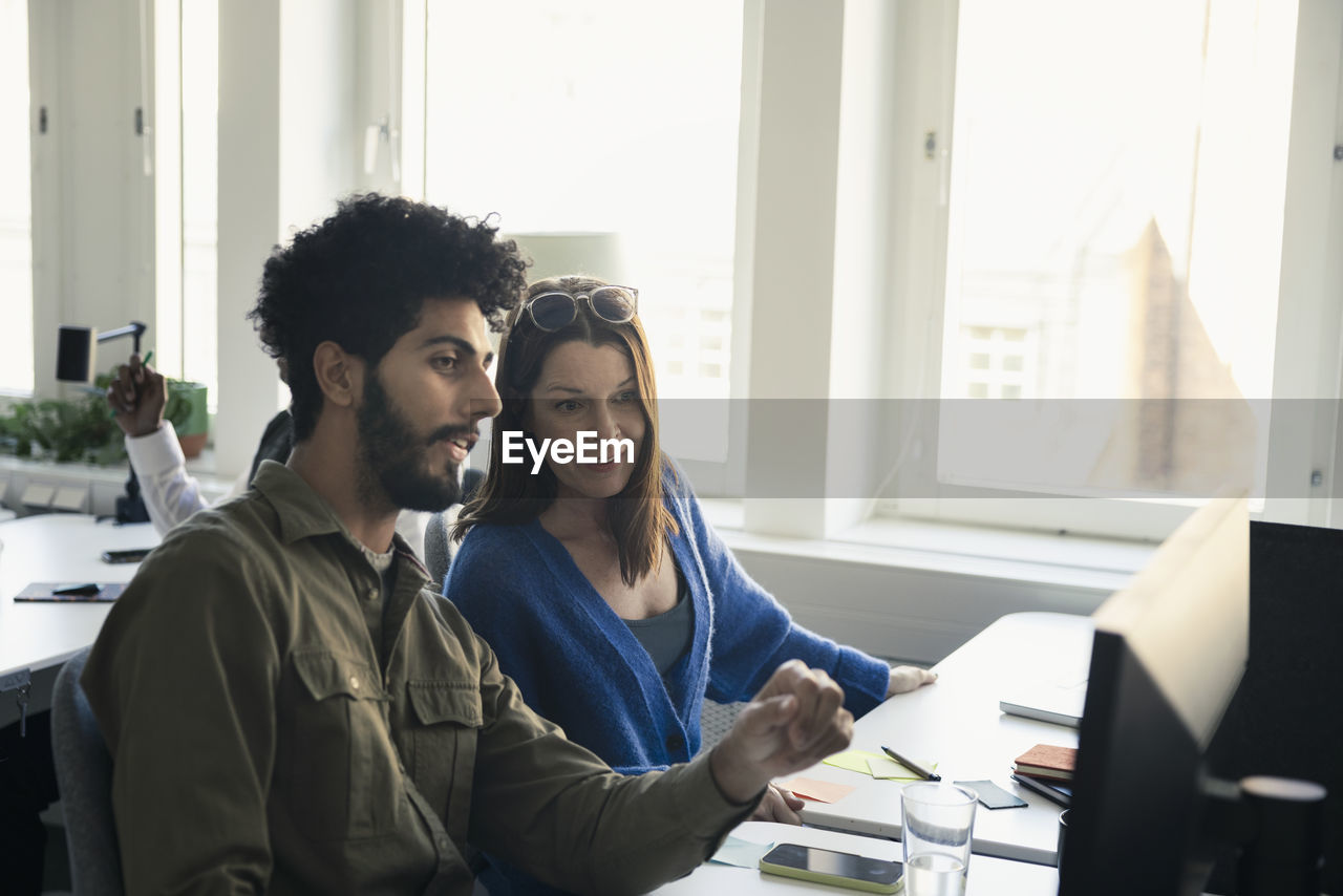 Two professionals discussing in office