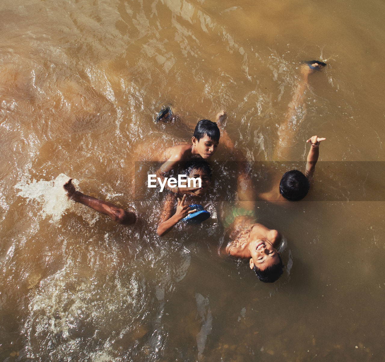 HIGH ANGLE VIEW OF PEOPLE IN SWIMMING POOL