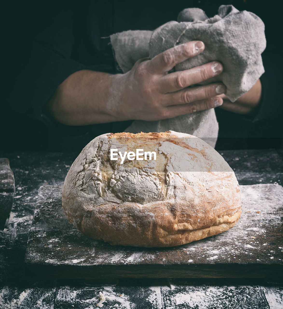 Close-up of person with bread at counter