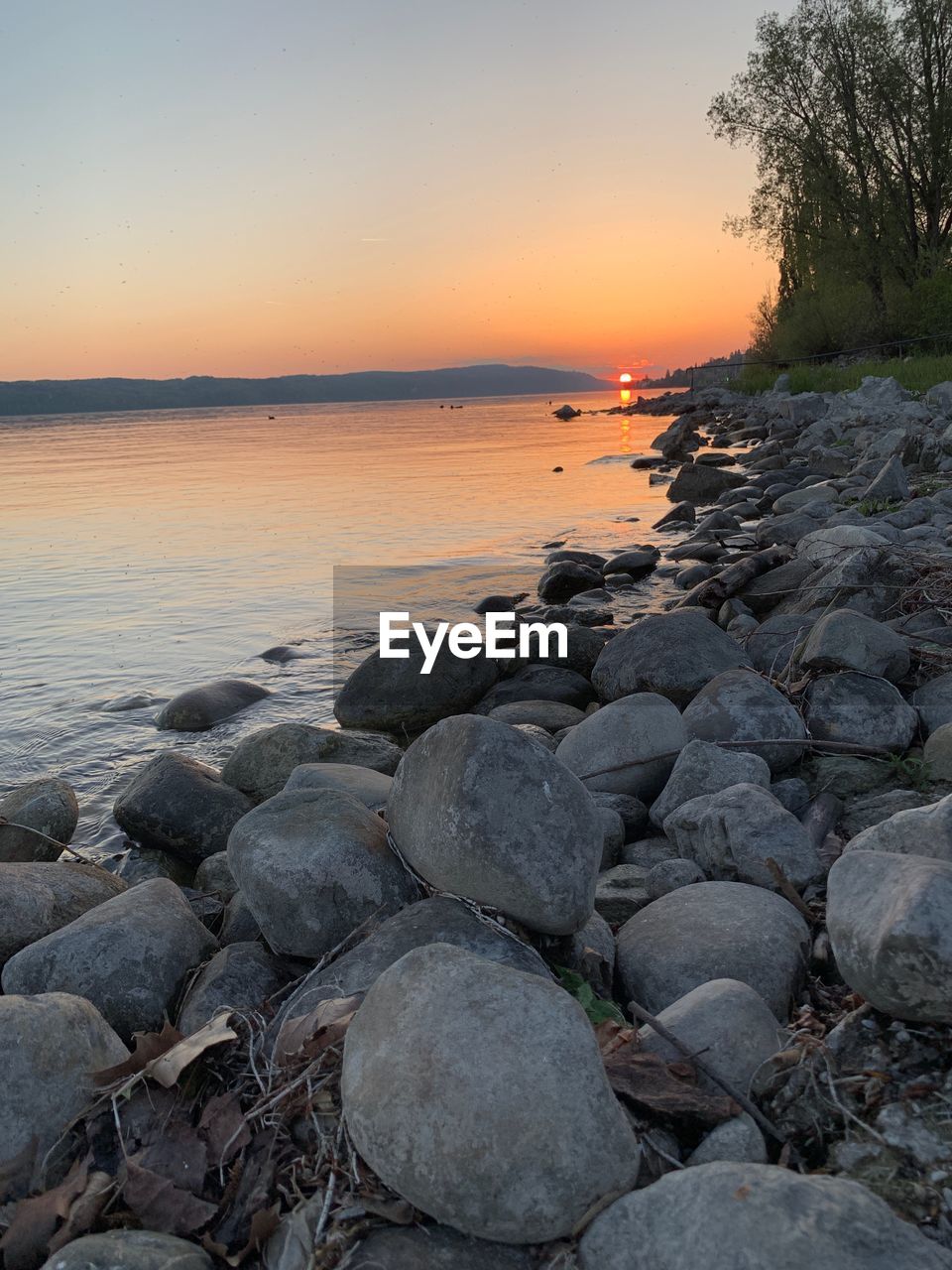 SCENIC VIEW OF SEA SHORE DURING SUNSET