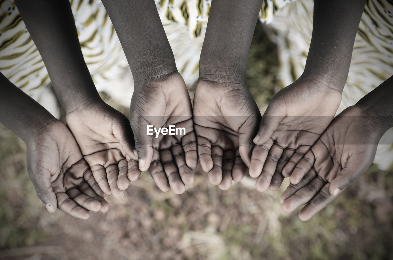 Midsection of children showing hands