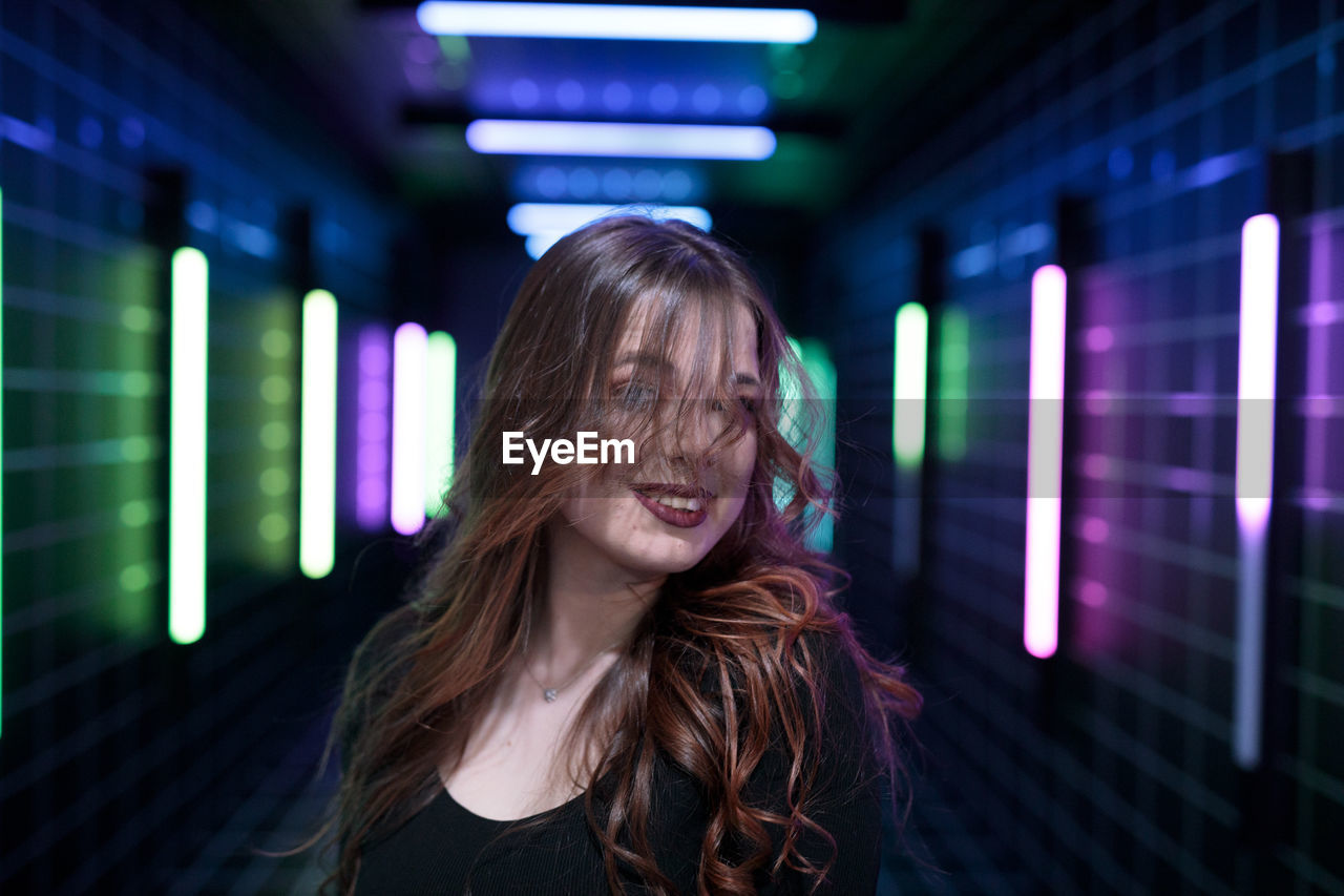 portrait of young woman looking away in city