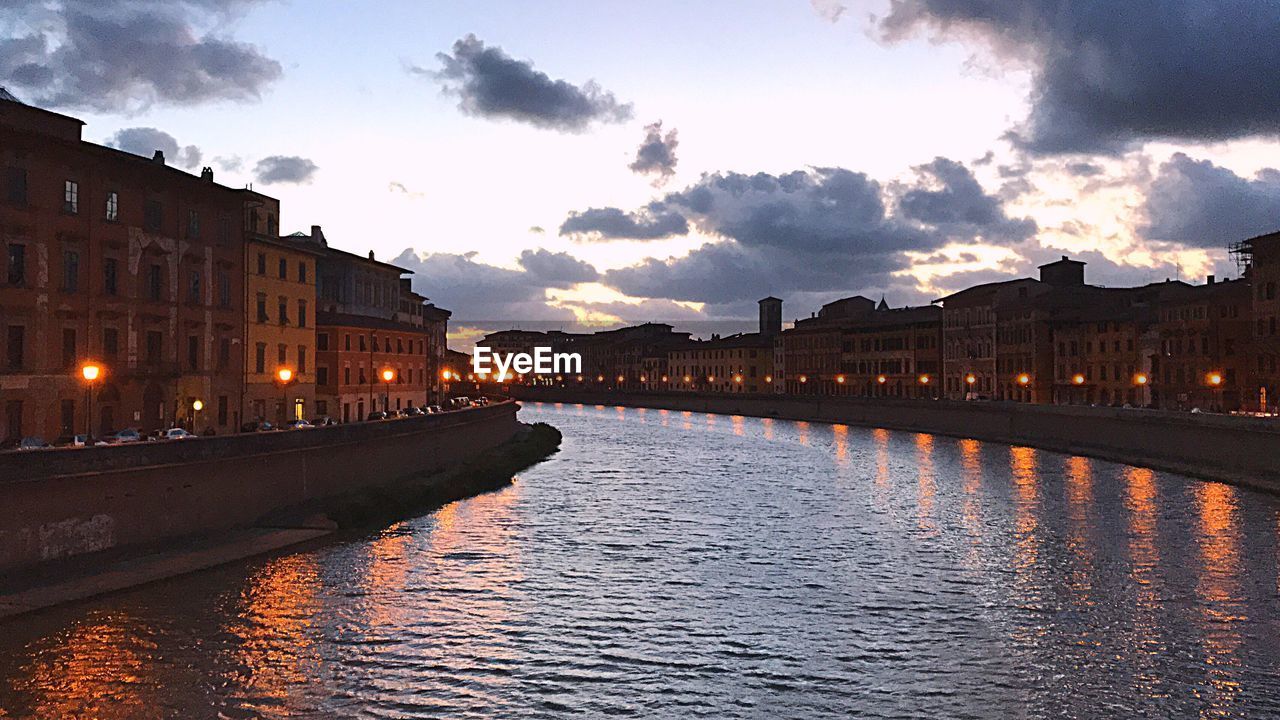 VIEW OF ILLUMINATED CITY AT WATERFRONT