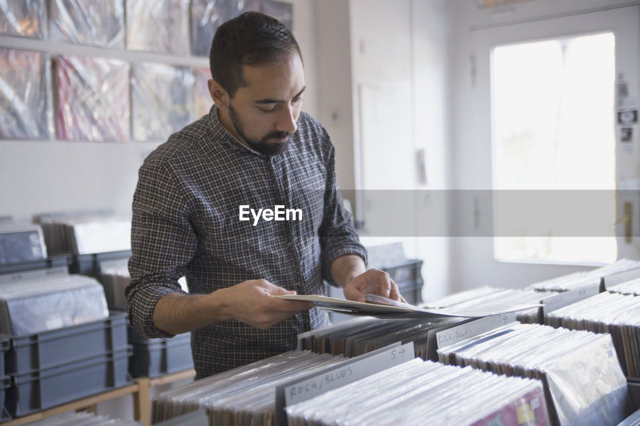 Young man shopping for records