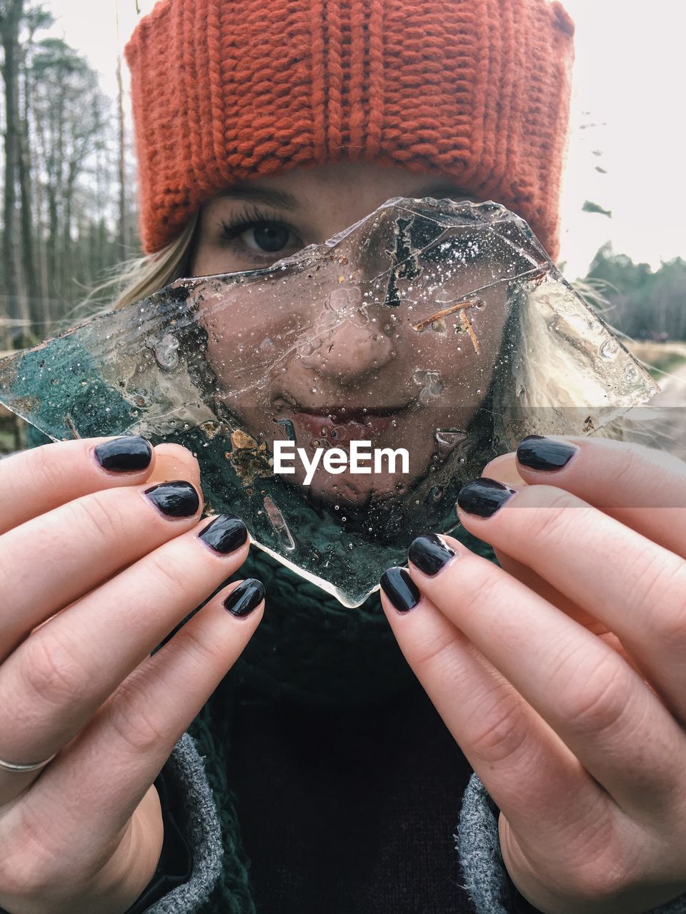 Portrait of young woman holding ice