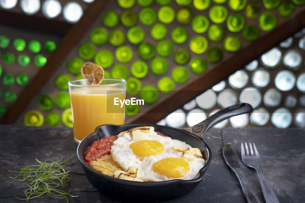 Majado, plantain mash with fried eggs, tomatoe sauce and orange juice, ecuadorian breackfast