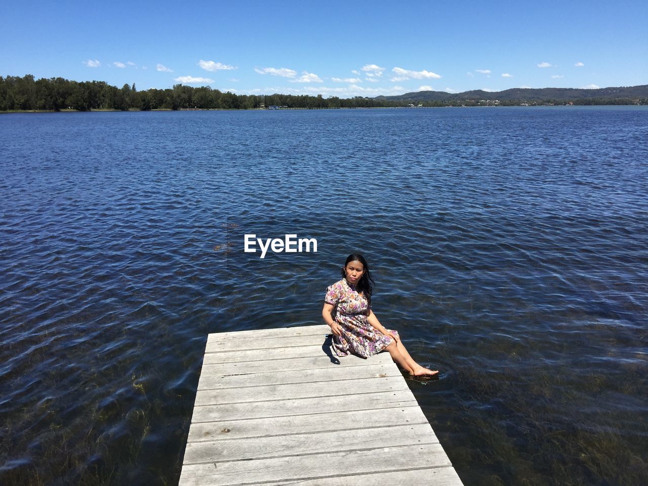 Full length of woman on pier over lake against sky