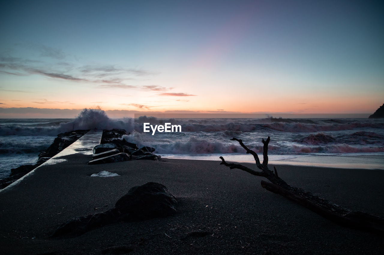 SCENIC VIEW OF BEACH DURING SUNSET