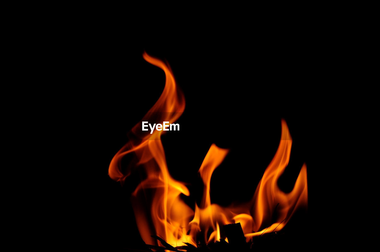 Close-up of fire burning over black background