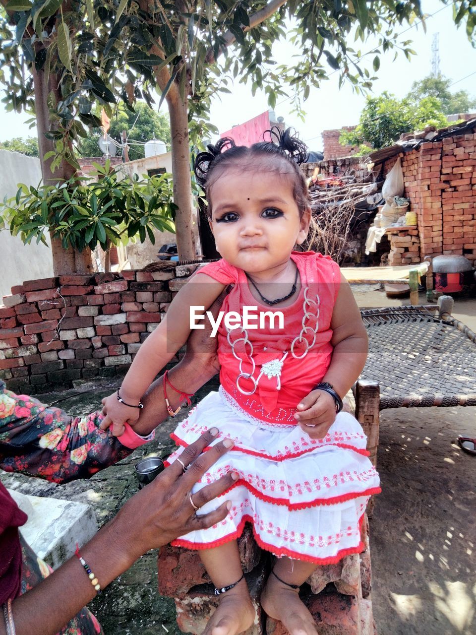 childhood, child, one person, female, women, looking at camera, front view, portrait, day, full length, cute, sitting, lifestyles, innocence, person, leisure activity, toddler, casual clothing, tree, clothing, spring, nature, plant, outdoors, smiling, human face, emotion, three quarter length, vacation, standing, happiness, holding, baby