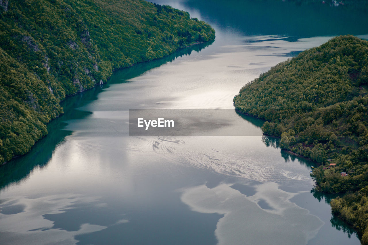 High angle view of river and trees against sky