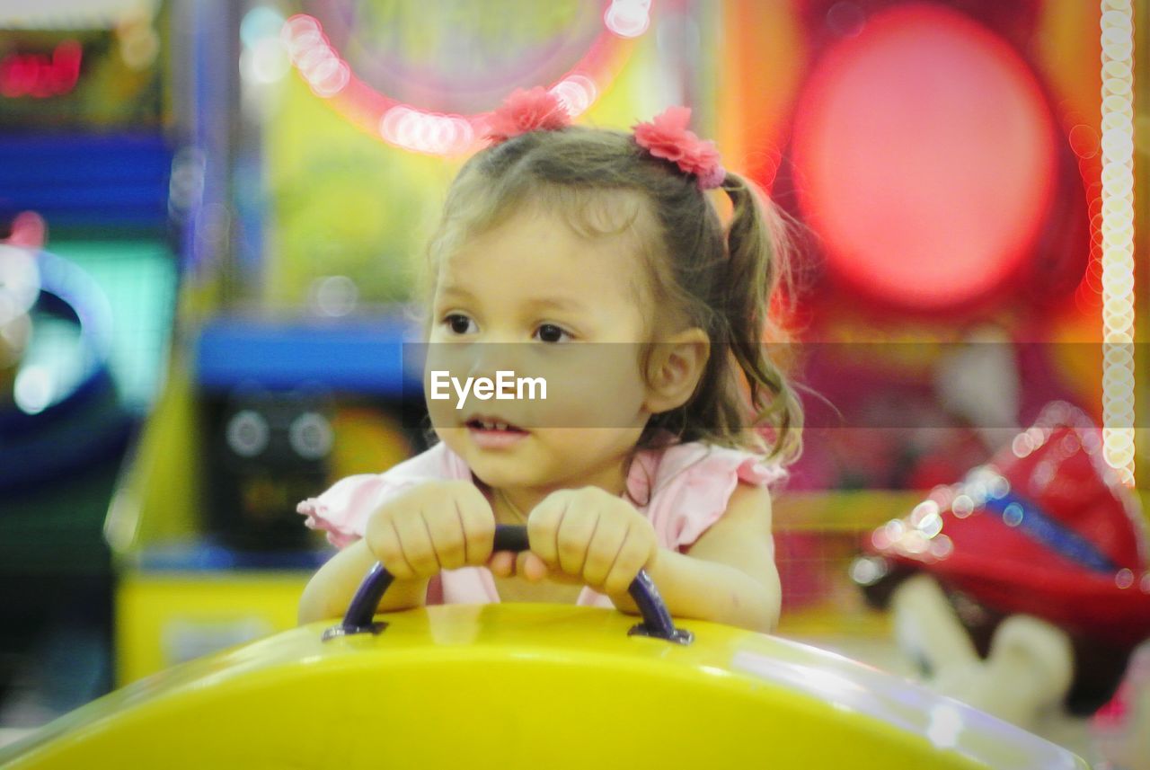 Close-up of cute girl on ride