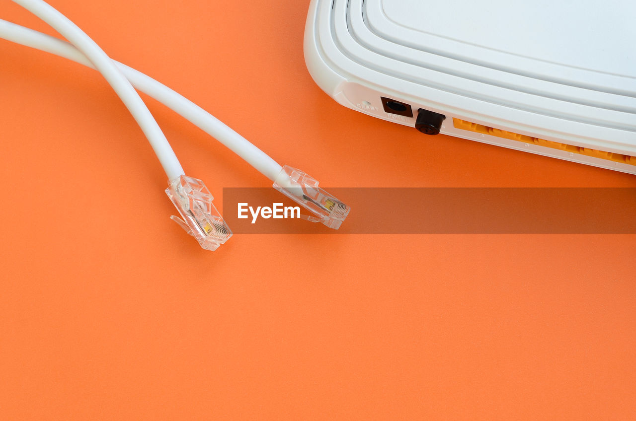 Computer cables and router on table