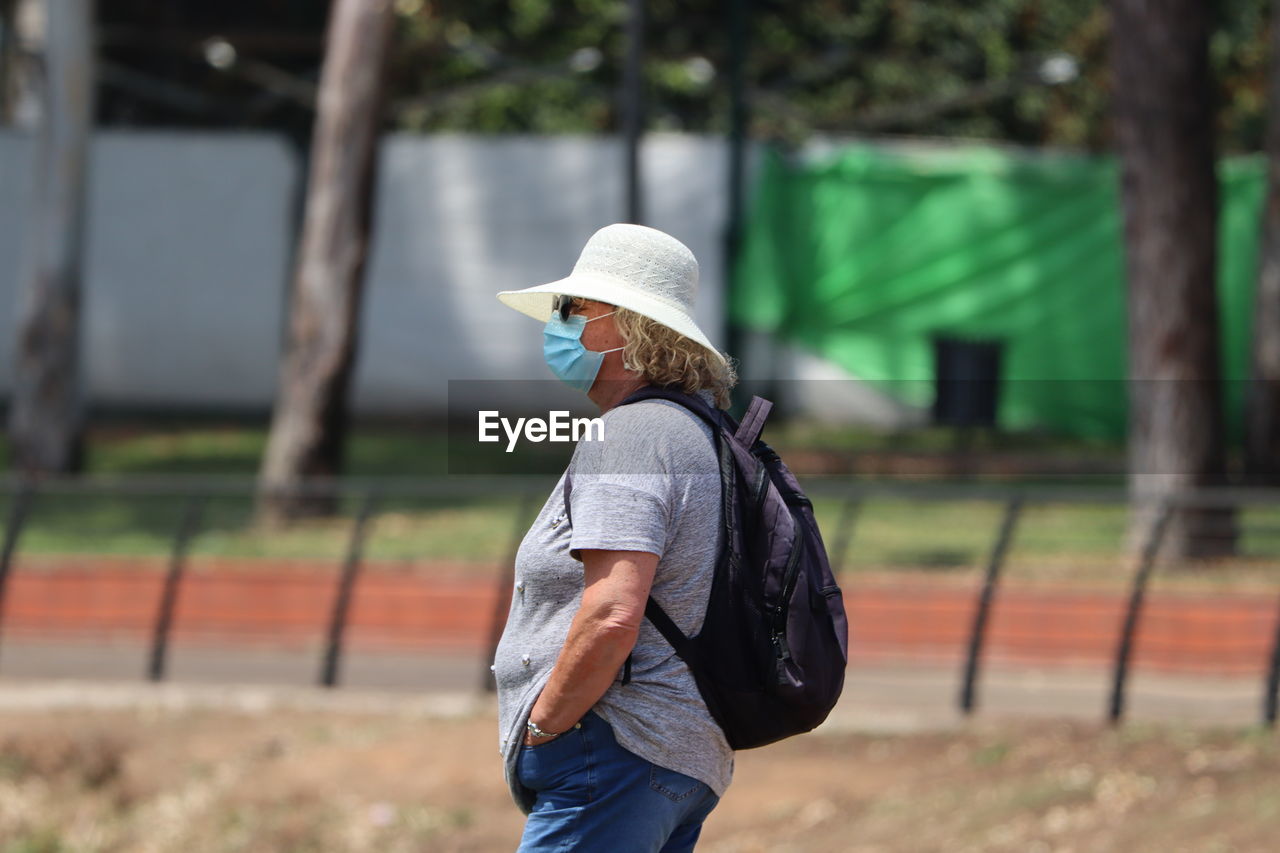 Side view of woman standing on field