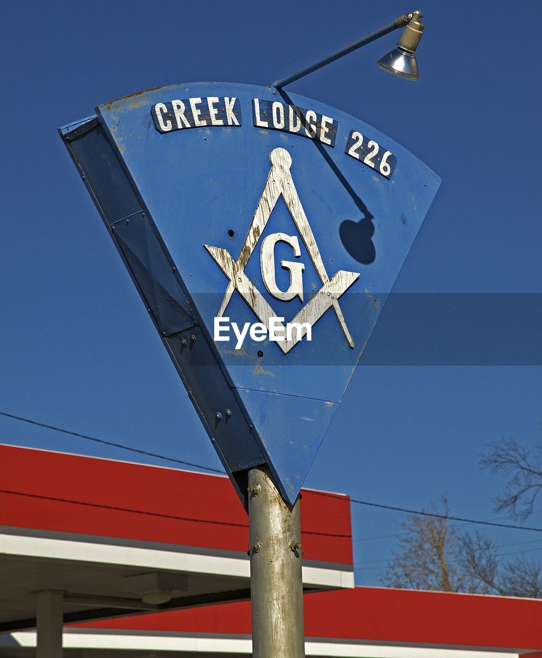 LOW ANGLE VIEW OF ROAD SIGNS AGAINST CLEAR BLUE SKY