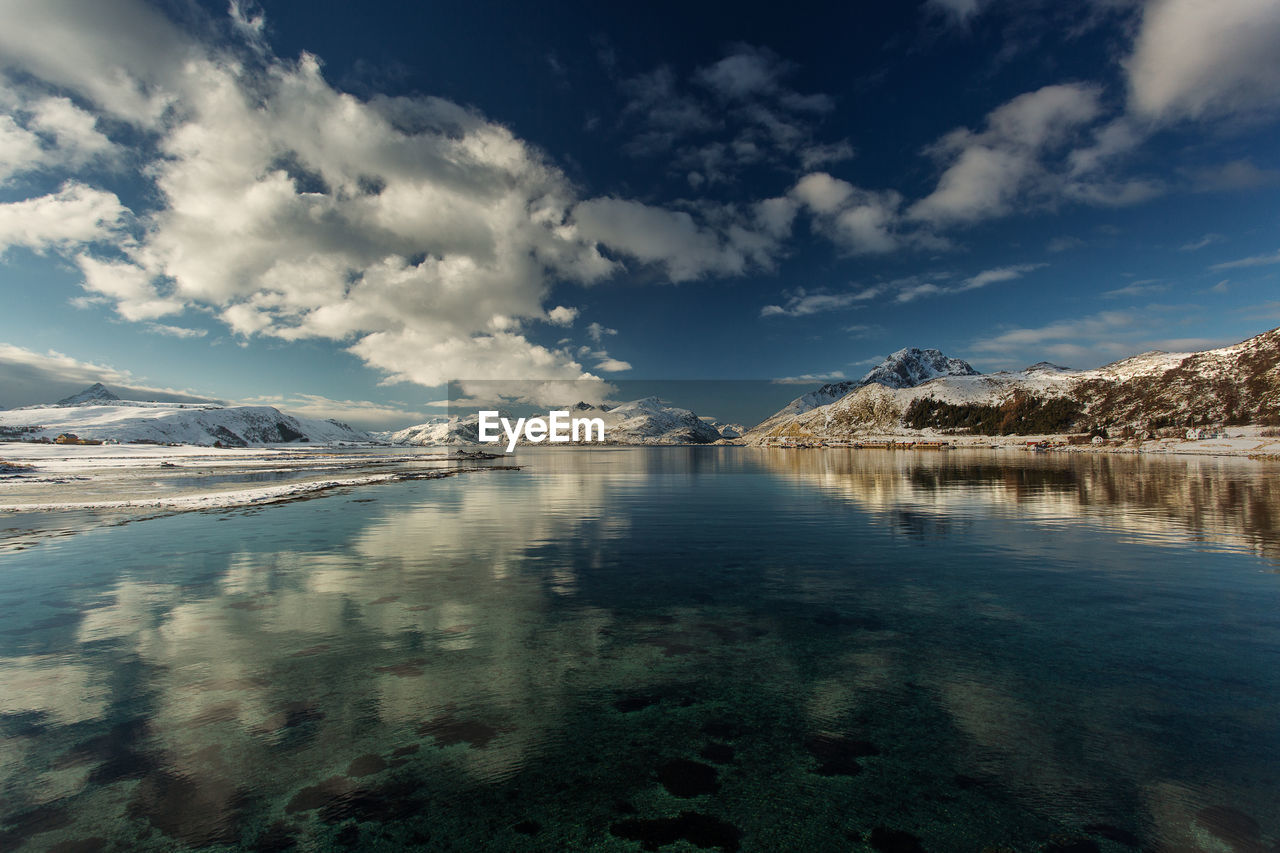 View of lake against mountain range during winter