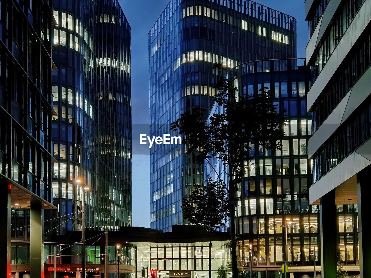 LOW ANGLE VIEW OF ILLUMINATED MODERN BUILDING IN CITY
