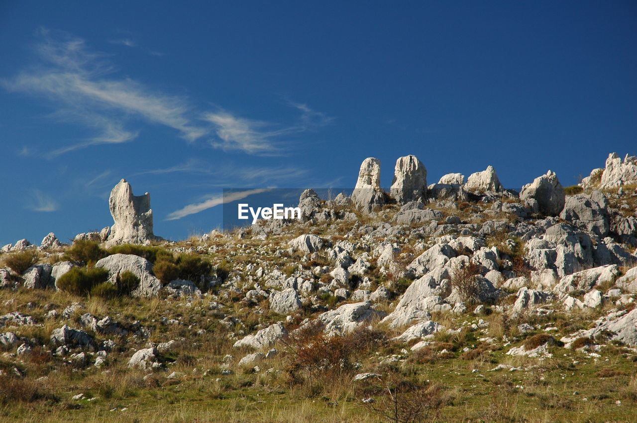 Low angle view of rock formations against sky