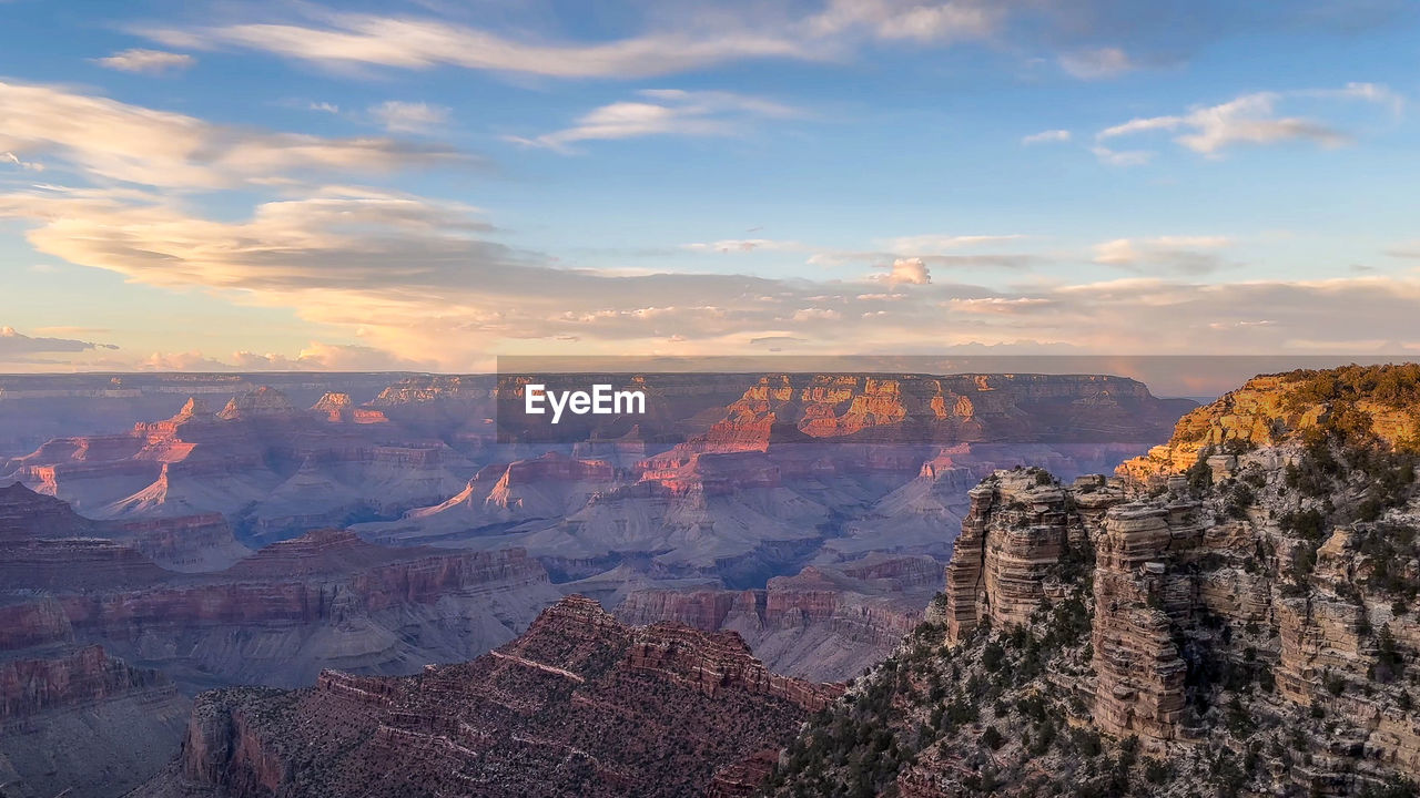 environment, landscape, scenics - nature, sky, rock, travel destinations, canyon, nature, travel, beauty in nature, cloud, sunset, rock formation, land, mountain, tourism, no people, non-urban scene, outdoors, escarpment, tranquility, cliff, national park, tranquil scene, horizon, high angle view, multi colored, tree, mountain range, idyllic, horizon over land, geology, sunlight, desert