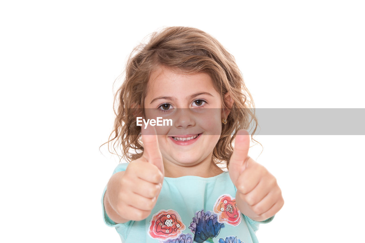 PORTRAIT OF CUTE GIRL AGAINST GRAY BACKGROUND