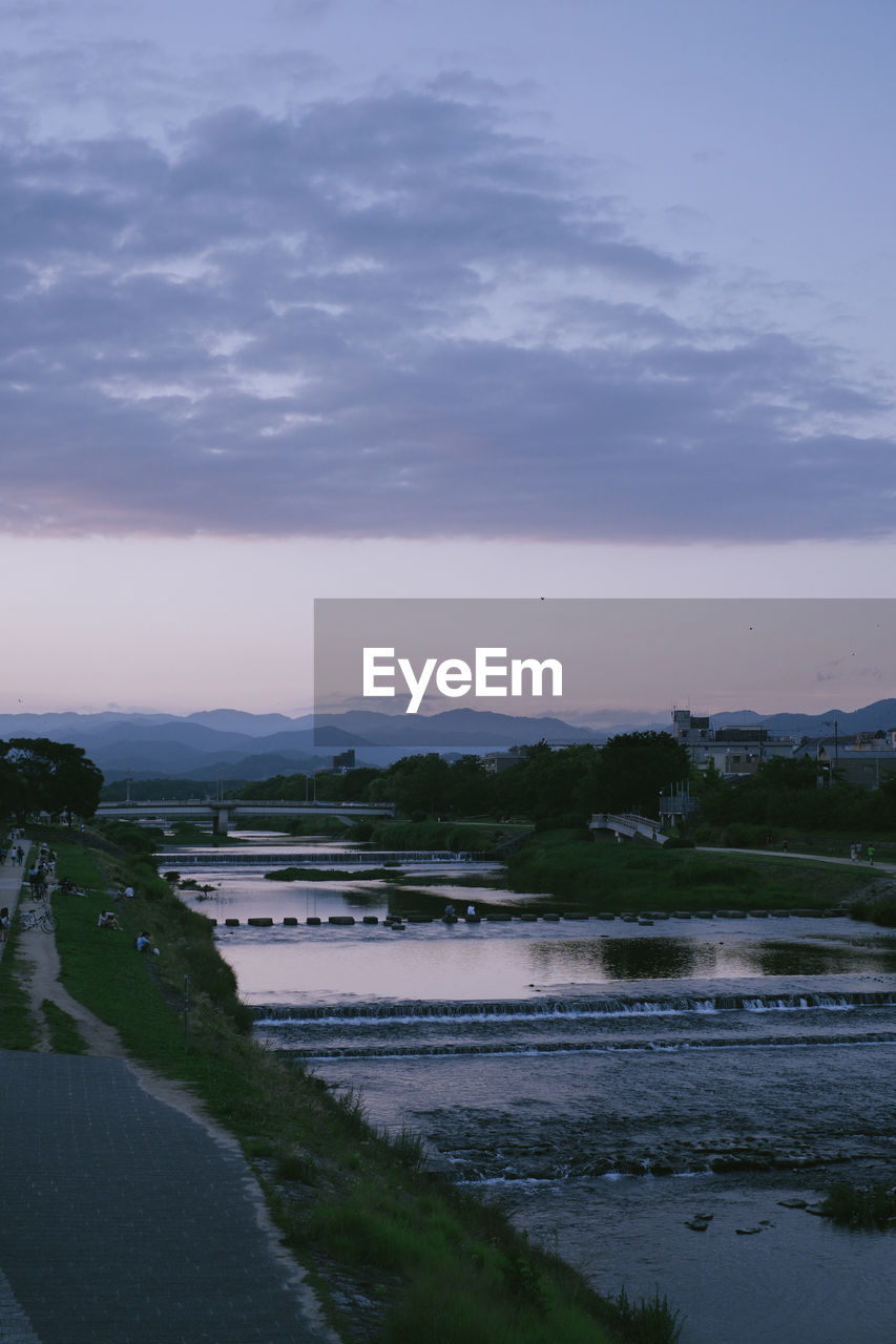 Scenic view of river against sky during sunset