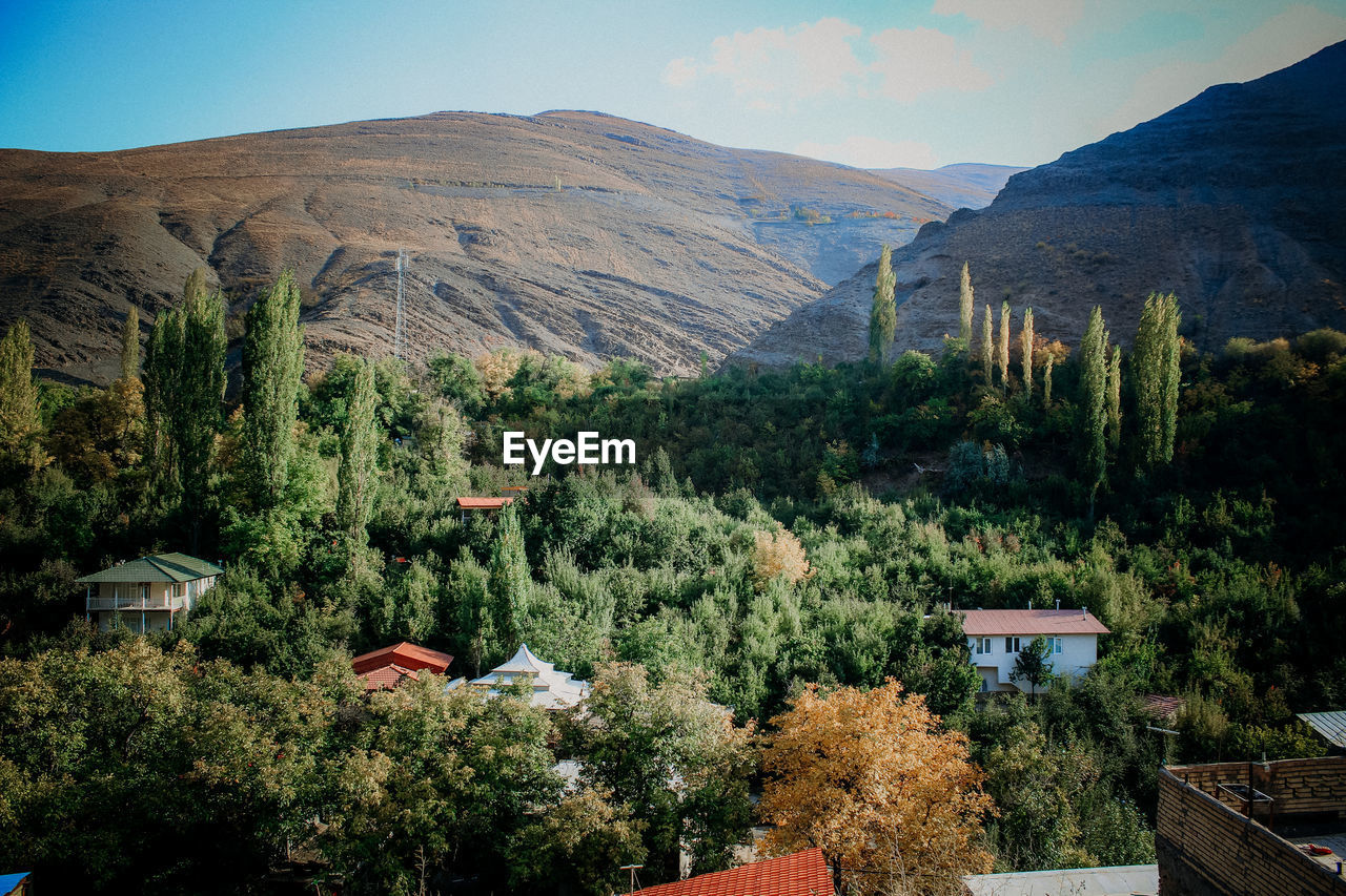 Scenic view of village among mountains 