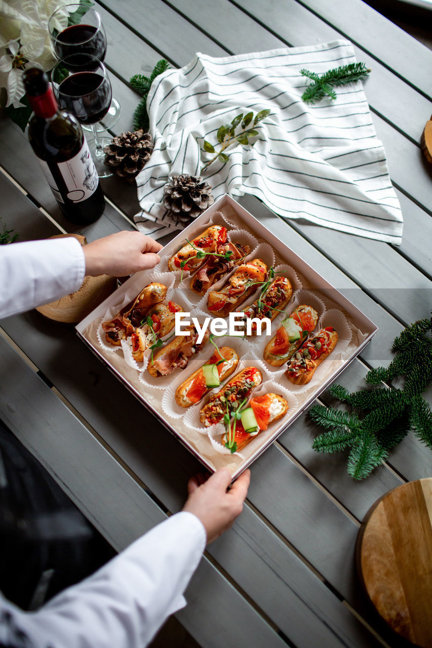 Eclairs with salmon, fresh vegetables and herbs, gourmet snacks.