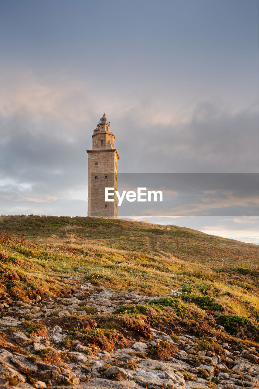 View of tower of hercules ancient roman lighthouse at sunset. galicia, spain. copy space