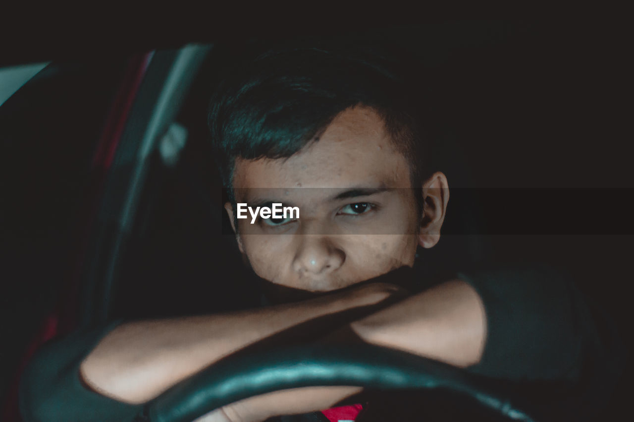 PORTRAIT OF YOUNG MAN WITH CAR