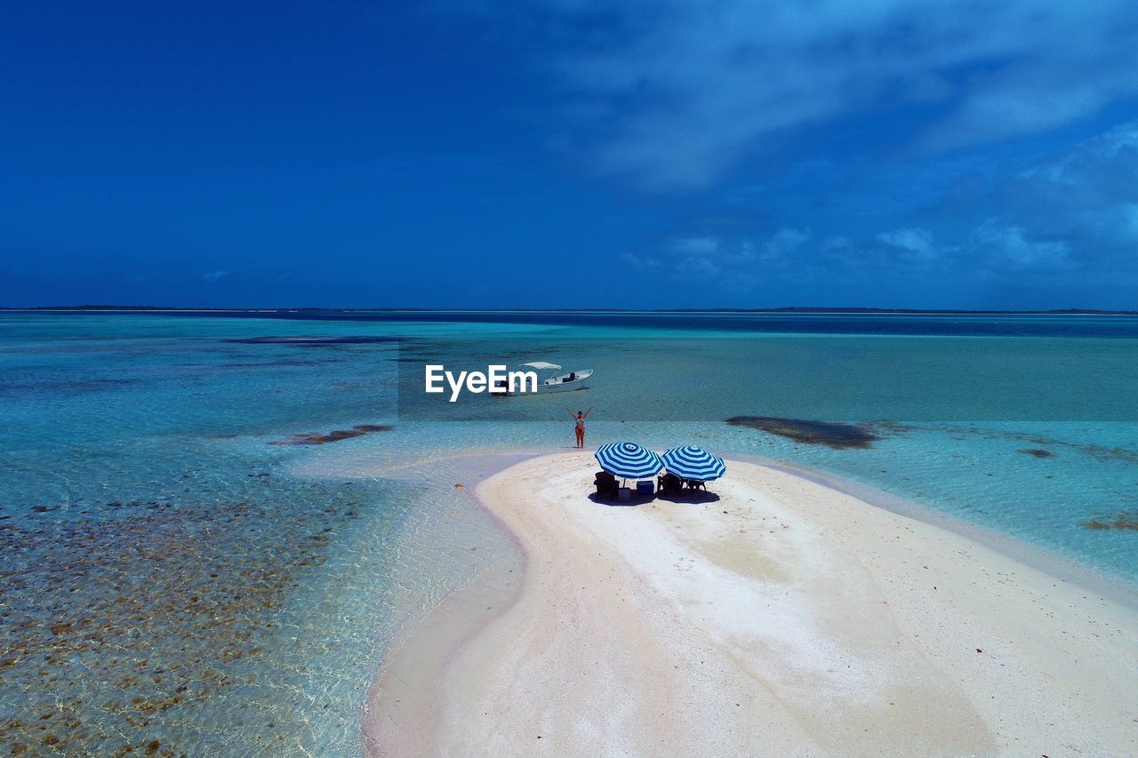 SCENIC VIEW OF BEACH AGAINST BLUE SKY