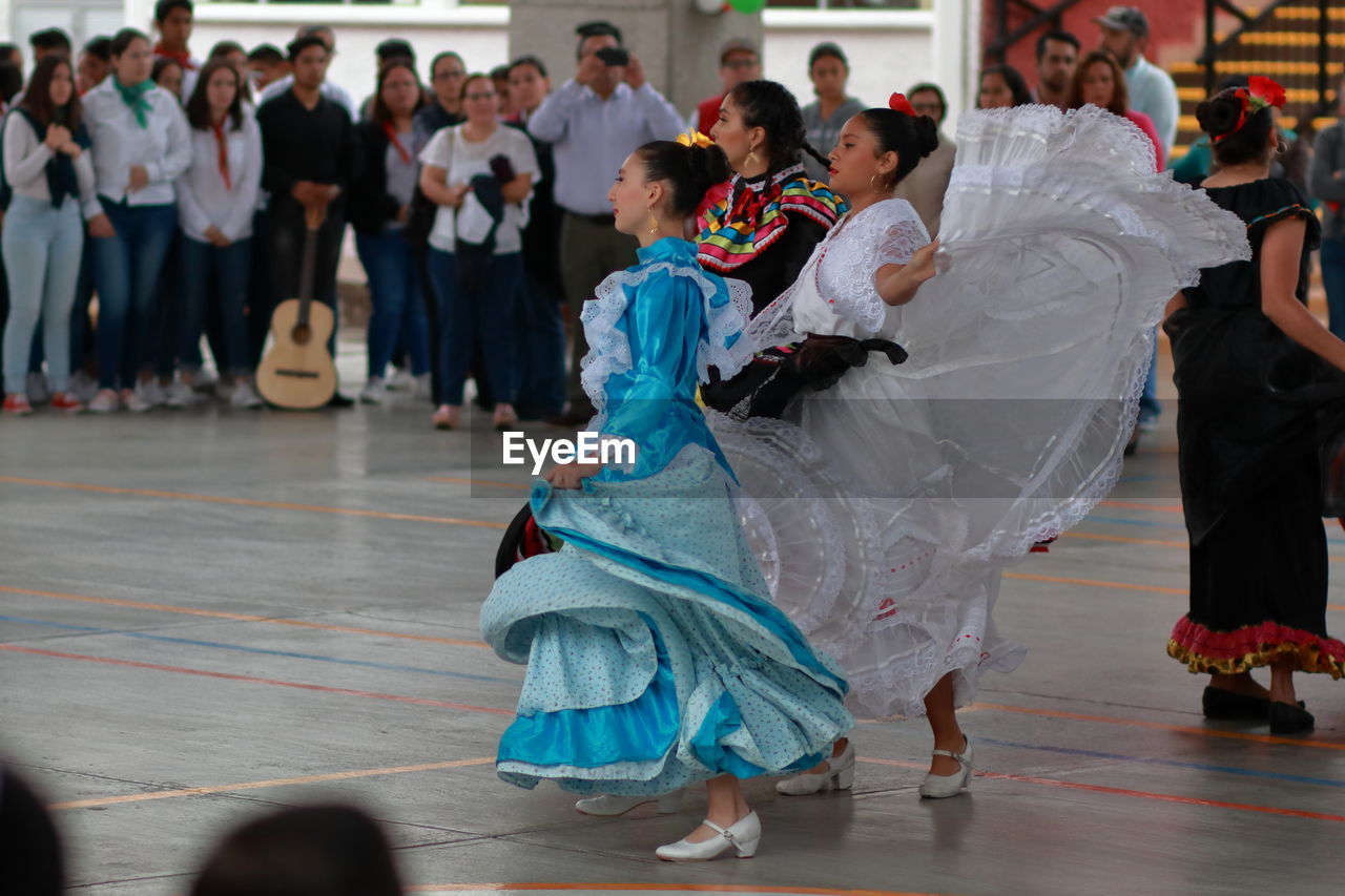 GROUP OF PEOPLE IN MARKET DURING FESTIVAL