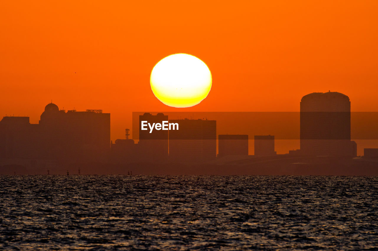 Scenic view of sea against orange sky