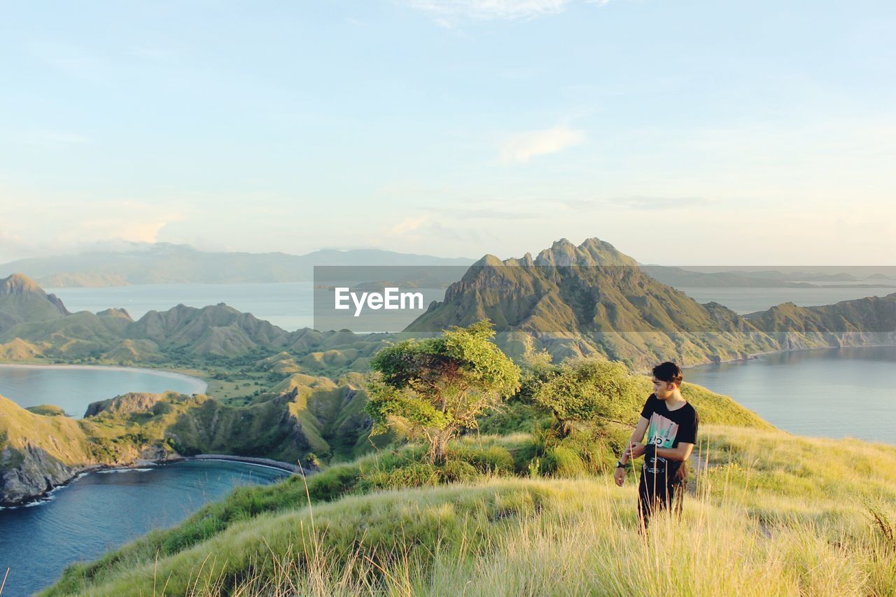 MAN LOOKING AT MOUNTAINS