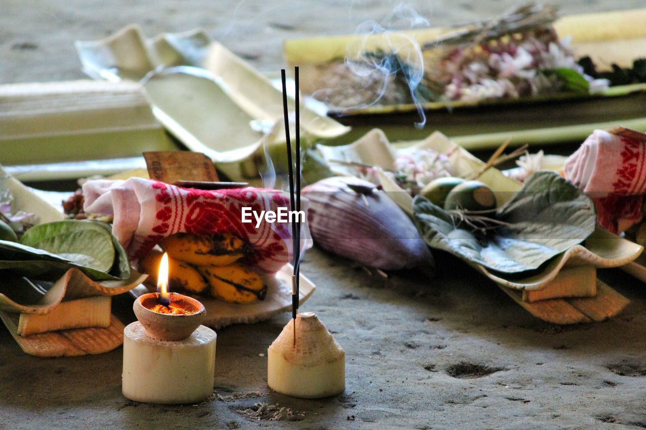 Close-up of religious offerings on table