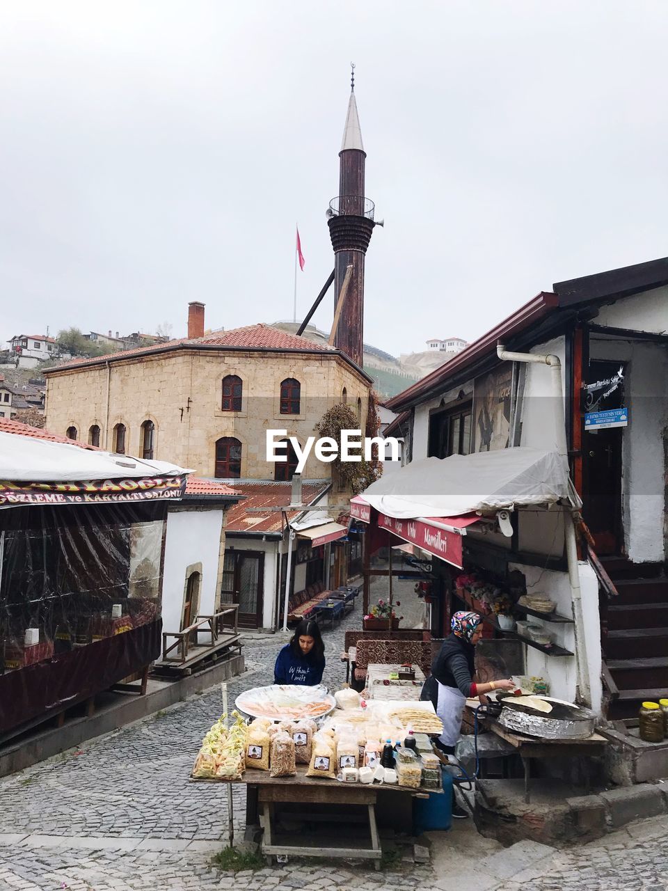 PEOPLE IN TRADITIONAL BUILDING AGAINST SKY