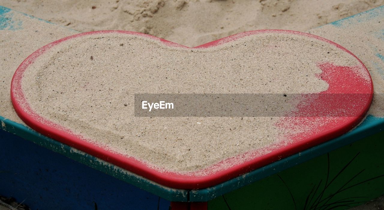 Close-up of heart shape object with sand