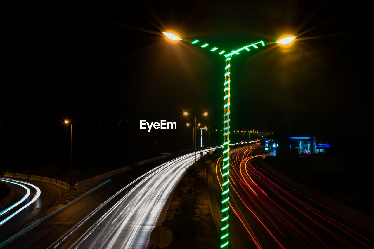 High angle view of light trails on road at night