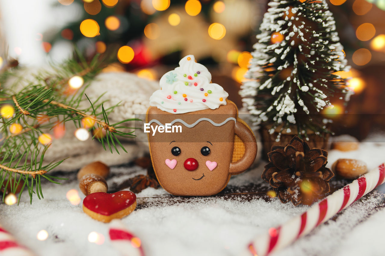 Christmas gingerbread cookie and decorations at christmas tree, gingerbread cup. high quality photo