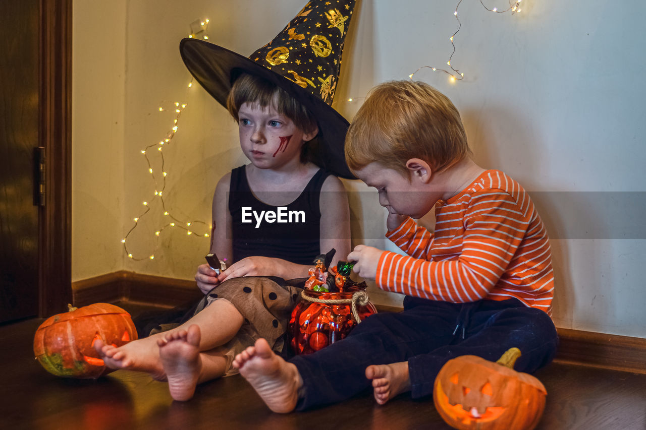 Children eat candies after halloween party.