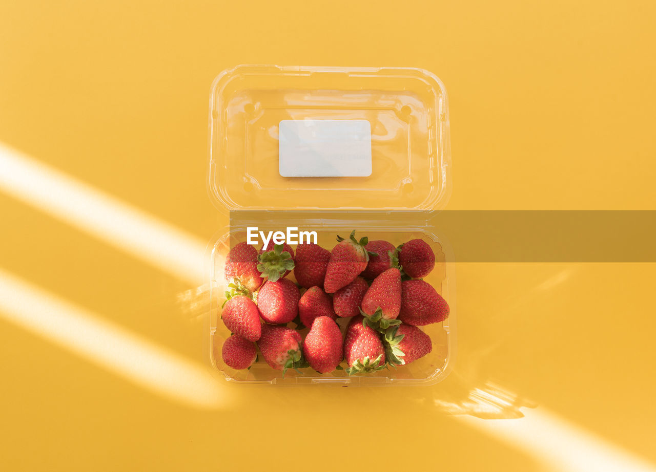 High angle view of strawberries in container on table